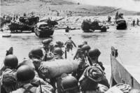 American soldiers and supplies arrive on the shore of the French coast