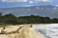 Snow-capped Haleakala serves as a backdrop as Paia, Maui's Scott Picton, left, plays a guitar
