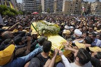 People carry the coffin of Hezbollah senior commander Taleb Sami Abdullah