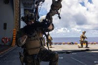 A Marine sets security during fast roping aboard the Wasp-class Amphibious Assault Ship USS Bataan