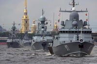 Russian warships sail along the Neva River during a naval parade rehearsal