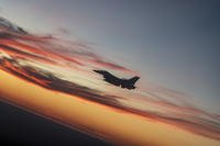 An F-16 Fighting Falcon from Eglin Air Force Base flies over a high school football game in Niceville, Fla.