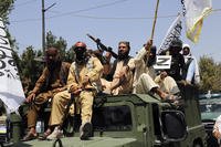 Taliban fighters celebrate the anniversary of the withdrawal of U.S.-led troops from Afghanistan.