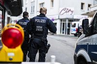 Police officers stand at a cordon in the city center in Solingen, Germany.