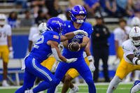 Air Force quarterback John Busha hands the ball off to Owen Allen