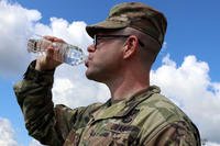 Staff Sgt. Shaun Martin, a combat medic assigned to Blanchfield’s LaPointe Army Medical Home on Fort Campbell, drinks from a bottle of water to maintain his hydration for optimal performance.