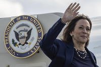 Democratic presidential nominee Vice President Kamala Harris waves as she boards Air Force Two at LaGuardia International Airport