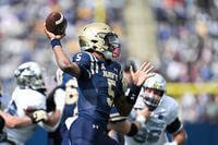 Navy quarterback Braxton Woodson throws on the Air Force defense