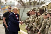 Former President Donald Trump greets members of the National Guard.