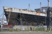 A person runs past the S.S. United States moored on the Delaware River in Philadelphia