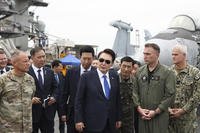 South Korean President Yoon Suk Yeol boards the USS Theodore Roosevelt aircraft carrier.