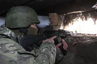 Russian soldier aims from a bunker in the Russian - Ukrainian border area in the Kursk region