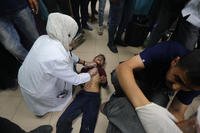 Injured Palestinians receive medical treatment at al Aqsa Martyrs hospital