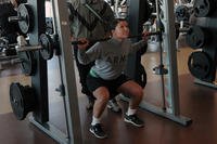 U.S. Army Sgt. Melissa Schimmel, an intelligence analyst with Headquarters and Headquarters Troop, 2nd Special Troops Battalion, 2nd Brigade Combat Team, 4th Infantry Division, performs squats at Fort Carson’s Iron Horse Sports and Fitness Center in Colorado Springs, Colo.