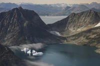 Icebergs are seen through a window of an airplane carrying NASA scientists as they fly on a mission to track melting ice in eastern Greenland.