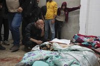 Palestinians mourn over relatives killed in an Israeli bombardment in Nuseirat, central Gaza