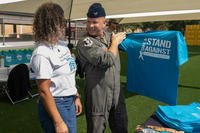 Luzmeilyn Camper, 23rd Wing sexual assault response coordinator, shares Sexual Assault Prevention and Response products with U.S. Air Force Col. Gary Symon, 347th Rescue Group commander, at Moody Air Force Base, Georgia.