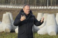 Poland's Prime Minister Donald Tusk speaks to reporters in Dabrowka, Poland, during a visit to Poland's border with Russia