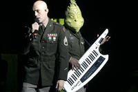 Staff Sgt. Shawn McGovern sings 'You're a Mean One, Mr. Grinch,' accompanied by the Grinch himself, during the 282nd Army Band's holiday performance in Columbia, S.C.