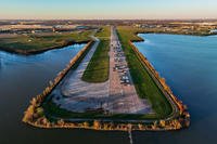 Automobiles fill a former runway at Hensley Field in December 2022, in Dallas.