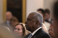 Defense Secretary Lloyd Austin listens as President Joe Biden speaks