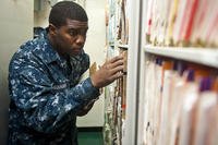 Hospital Corpsman Jay Jenkins files medical records aboard the aircraft carrier USS John C. Stennis (CVN 74).