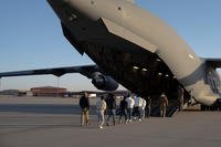 Migrants board a removal flight at Fort Bliss, Texas