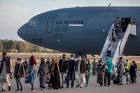 Afghan evacuees disembark from a U.S. Air Force plane at Rota Naval Base