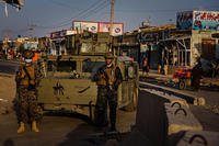 Taliban fighters widen the perimeter outside the airport in Kabul