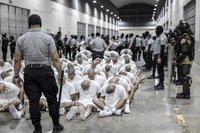 Guard transfers deportees to the Terrorism Confinement Center in El Salvador