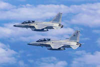 Two Philippine Air Force FA-50 fighter jets fly during a joint patrol and training session with the U.S. over the South China Sea.