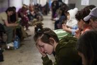 A woman sits in a school basement being used as a shelter after a Russian airstrike