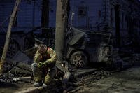 A rescue worker rests near university building destroyed by a Russian missile strike on Sumy, Ukraine.