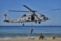 Turkish navy soldiers descend from a Sikorsky helicopter as part of the NATO Dynamic Mariner/Flotex-25 naval exercise in Barbate