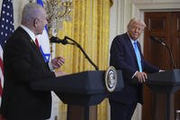 President Donald Trump listens as Israel's Prime Minister Benjamin Netanyahu speaks during a news conference