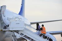 Venezuelans board a plane.
