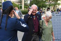 Medal of Honor recipient Robert Patterson, escorted by his wife Linda, returns a salute from Master Sgt. Elizabeth Reidling, volunteer from Hanscom Air Force Base, Mass., as they enter the Congressional Medal of Honor Society Convention Mayor’s Reception in Boston.
