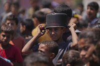 A young Palestinian waits to collect donated food.