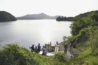 Firefighters gather for a search operation as a Japanese air force plane crashed after taking off for a training flight