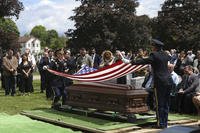 An American flag is folded during the interment for U.S. Army Air Forces Staff Sgt. Eugene Darrigan