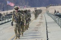 U.S. Army soldiers cross a floating bridge on the Imjin River