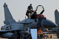 Military personnel prepare to cover a Chengdu Aircraft Corporation J-10C for the People's Liberation Army Air Force (PLAAF)