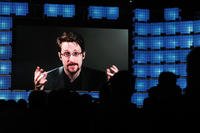 Former U.S. National Security Agency contractor Edward Snowden addresses attendees through video link at the Web Summit technology conference in Lisbon.