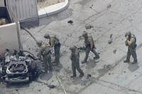 Law enforcement investigate a vehicle after an explosion in Palm Springs