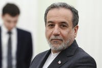 Iranian Foreign Minister Abbas Araghchi stands waiting