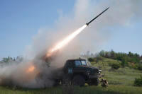 Ukraine's 30th Separate Mechanized Brigade fires a rocket toward Russian