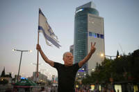 A demonstrator takes part in a performance during a protest.