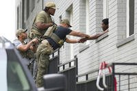 Armed Officers place handcuffs on a man northwest Washington DC
