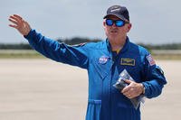 NASA astronaut Butch Wilmore waves to the media