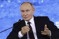 Russian President Vladimir Putin gestures
